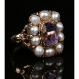 A gold, amethyst and seed pearl cluster ring, mounted with the cushion shaped amethyst within a