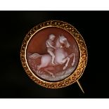 A French gold mounted circular sardonyx cameo brooch, carved as a horse and rider within a beaded