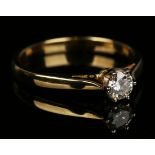 An 18ct gold and diamond single stone ring, claw set with a circular cut diamond, ring size approx