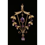 A gold, mauve paste and seed pearl pendant, decorated with a foliate border and a pear shaped