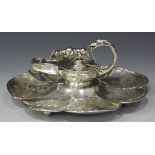 A Victorian silver inkstand of scallop shell form with reeded rim and engraved with foliate scrolls,