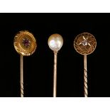 A gold topped and diamond set stick pin, star set with a cushion shaped diamond, detailed '15', a