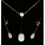 A 9ct gold and opal two stone pendant necklace, claw set with the principal oval opal to the drop