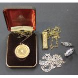 A silver gilt ingot shaped pendant with a neckchain, a silver gilt pendant medallion with a