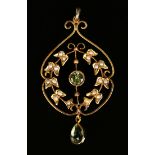 A gold, peridot and seed pearl pendant, mounted with a circular cut peridot within a wreath shaped