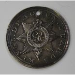 A silver regimental medal of circular form, detailed to the obverse with a crowned garter star and