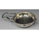 A George III silver lemon strainer, the pierced circular bowl with gadrooned rim, flanked by a