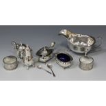 A George V silver sauce boat with scroll handle, Sheffield 1935 by Viner's Ltd, a pair of silver