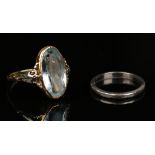 A platinum plain wedding ring, ring size approx I1/2, and a gold and pale blue gem set solitaire