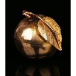 A gold pendant pillbox in the form of an apple, the hinged cover with a stem and leaf finial, height