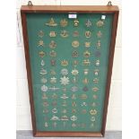 A collection of seventy-four British cap badges, including W.A.A.C., Queen Mary's A.A.C., Royal