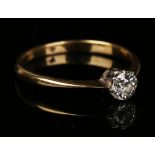 A gold and diamond single stone ring, claw set with a cushion shaped diamond, detailed '18', ring