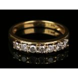 An 18ct gold and diamond seven stone half-hoop ring, mounted with circular cut diamonds, detailed '