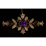 A gold, amethyst and seed pearl bar brooch of foliate scroll form, collet set with the oval cut