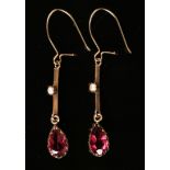 A pair of gold, garnet and seed pearl pendant earrings, each mounted with a pear shaped garnet