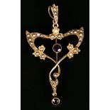 A gold, amethyst two stone and seed pearl pendant in a scrolling design, mounted with a circular cut