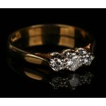 An 18ct gold and diamond three stone ring, claw set with circular cut diamonds, ring size approx