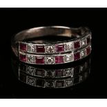 A diamond and ruby half-hoop ring, mounted with eight circular cut diamonds alternating with