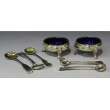 A pair of George III silver circular salts, each with beaded rim on hoof feet, fitted with blue