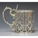 A Victorian silver cylindrical mustard, the hinged lid engraved with a foliate scroll border, the