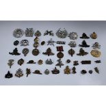 A small collection of Second World War period and later cap badges, including Tyneside Scottish,