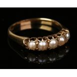 A gold ring, mounted with a row of five half cultured pearls, detailed '18ct', ring size approx M,