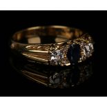 An 18ct gold, sapphire and diamond ring, mounted with the oval cut sapphire between two principal