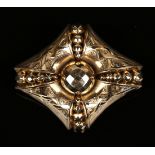A Victorian gold cased lozenge shaped brooch, the centre with a faceted bead motif, otherwise with