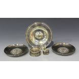 A pair of silver circular dishes, each centre decorated with a twin headed eagle against a