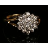 An 18ct gold and diamond cluster ring, mounted with circular cut diamonds in a flowerhead design