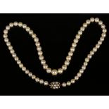 A single row necklace of graduated cultured pearls on a gold and half-pearl set cluster clasp,