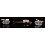 A pair of gold and moonstone oval cufflinks, the fronts mounted with oval moonstones, the backs with
