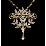 A two colour gold, diamond and cultured pearl pendant of scrolling stem form with foliate detail,