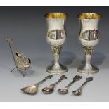 A pair of silver goblets, each waisted bowl on a fruiting vine decorated baluster stem and