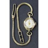 An Accurist 9ct gold circular cased lady's wristwatch on as 9ct gold Brazil link bracelet, with a