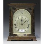 A George V oak cased mantel clock with eight day three train movement quarter striking and chiming