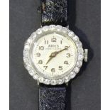 An Aries platinum cased and diamond set lady's dress wristwatch, the signed circular silvered dial