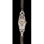 A platinum cased and diamond set lady's dress wristwatch, the circular silvered dial with black