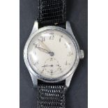 A steel backed and base metal fronted MOD issue circular cased gentleman's wristwatch, the