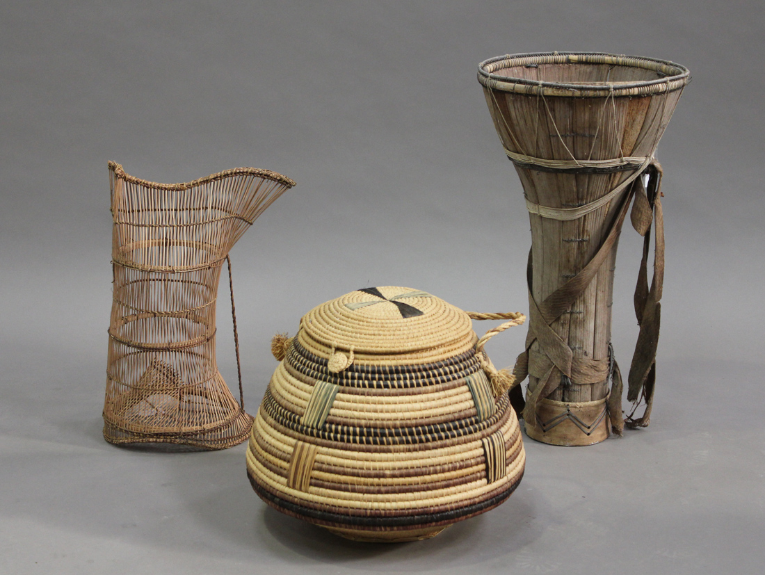 A Malawian wicker fish trap, length 51cm, a Senegalese basket and a North Bornean carrying basket.