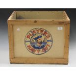 A collection of various advertising tins, contained within a Player's Navy Cut wholesaler's crate,