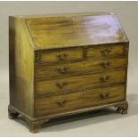 A George III mahogany bureau, the fall front with inlaid decoration above two short and three long