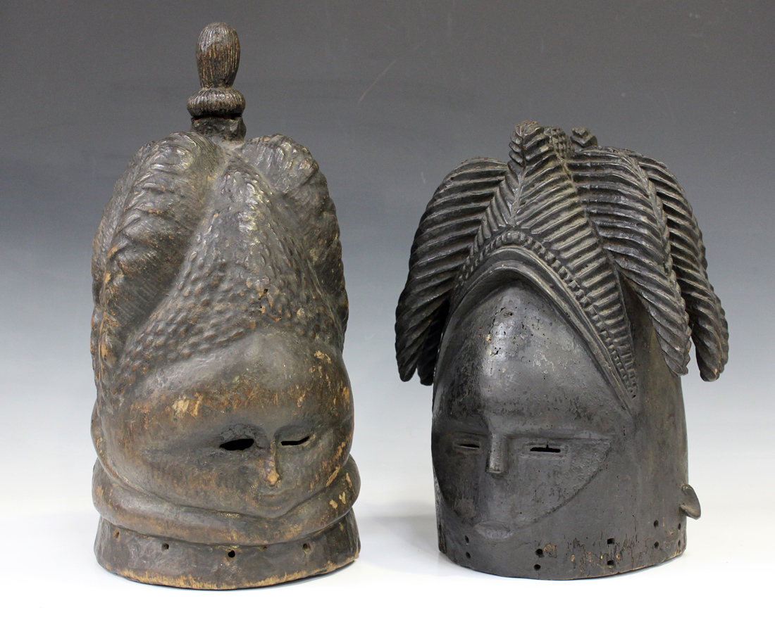 Two West African carved softwood Mende Bundu helmet masks, probably Liberian, worn by the secret