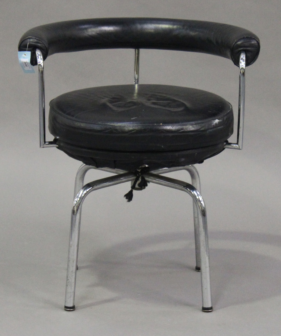 A late 20th century LC7 style swivel armchair, after a design by Le Corbusier, with black leather
