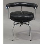 A late 20th century LC7 style swivel armchair, after a design by Le Corbusier, with black leather