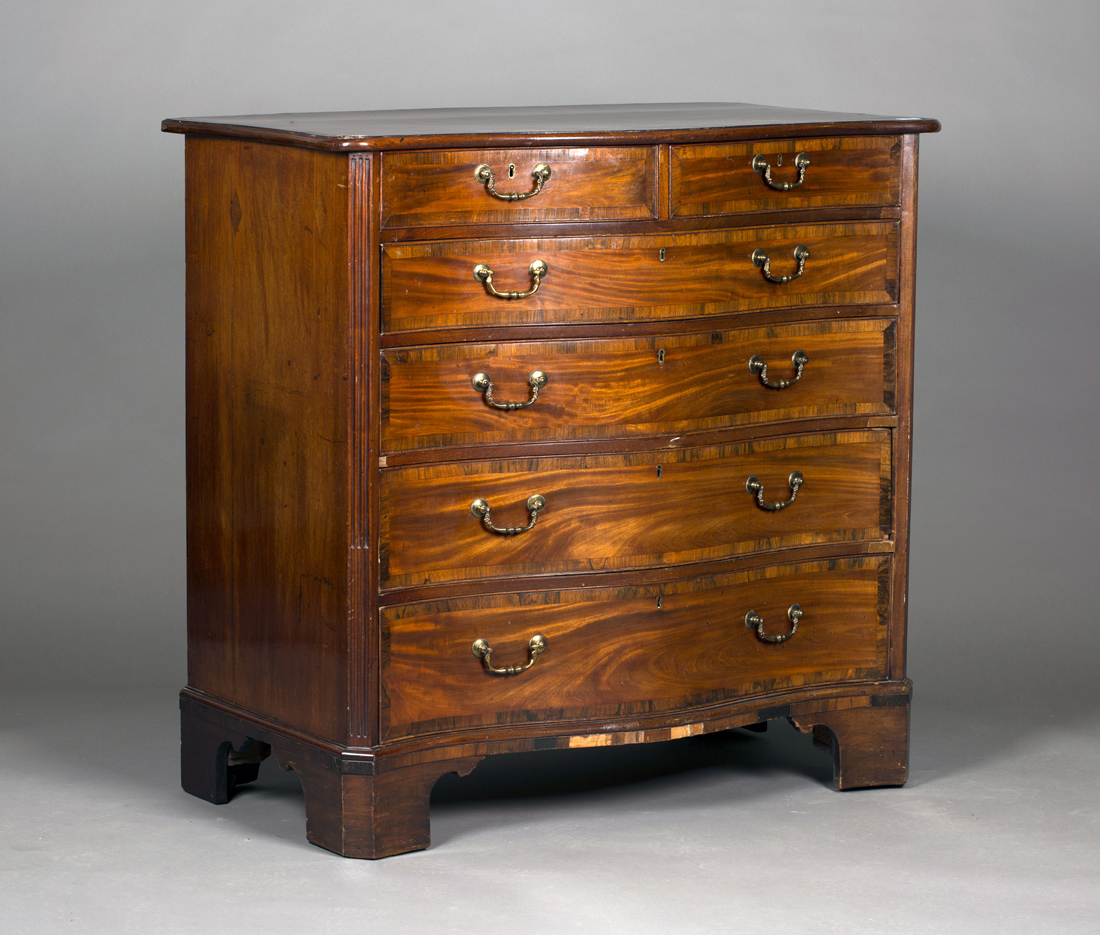 A George III mahogany serpentine fronted chest with rosewood crossbanded decoration, fitted with two