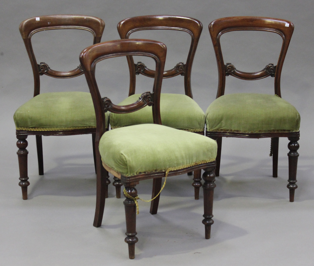 A set of four Victorian mahogany balloon back dining chairs, upholstered in green velour, raised
