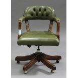 A 20th century walnut and green leather revolving office armchair, height 80cm, width 59cm. Buyer’
