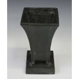 A 20th century black/green patinated cast bronze urn with waisted square body, on paw feet and a