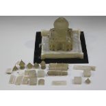 A late 19th century Indian alabaster sectional model of the Taj Mahal, raised on a slate plinth,